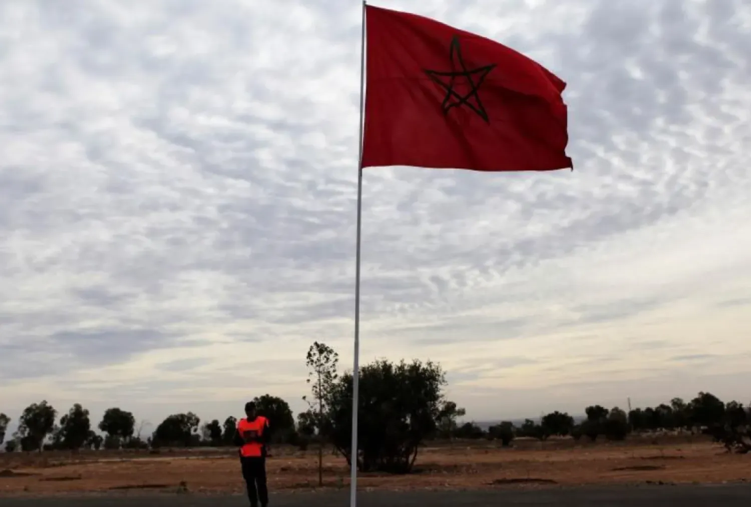 File photo of a police officer standing near a Moroccan national flag near the main stadium during preparations for the FIFA Club World Cup in Agadir, December 10, 2013. REUTERS/Amr Abdallah Dalsh
