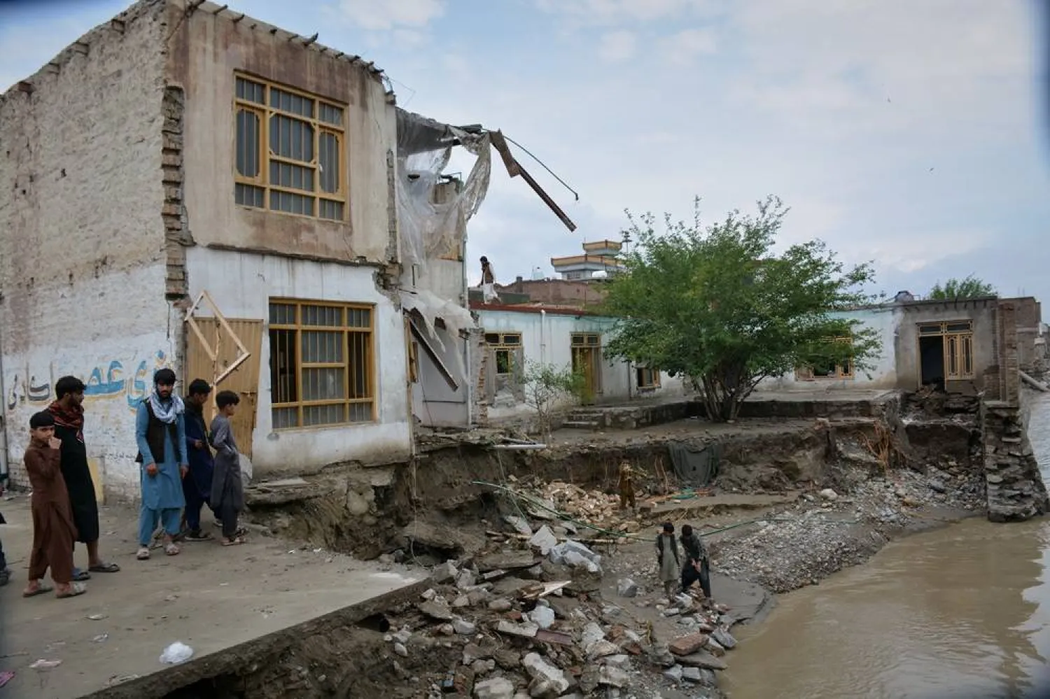 Residents inspect a building that partially collapsed due to heavy flooding in Jalalabad, Afghanistan, Saturday, April 4, 2026. (AP) 