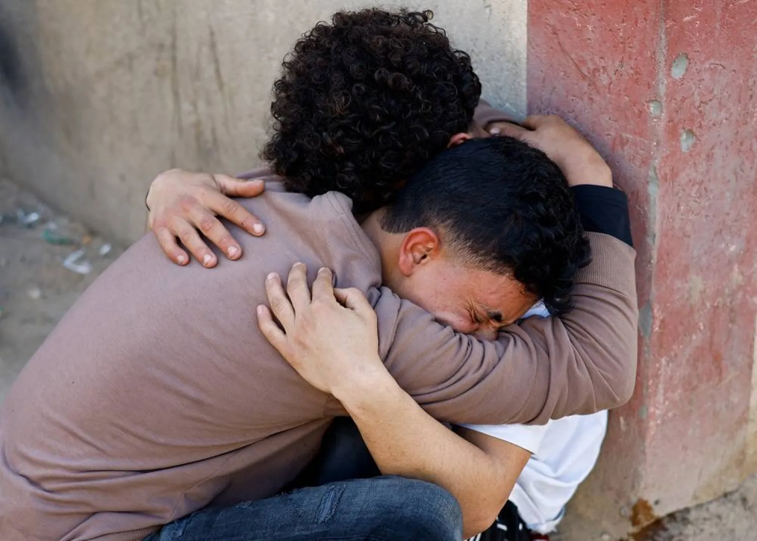  Palestinians react following an Israeli strike outside a school sheltering displaced people, according to medics, at Al-Aqsa Martyrs Hospital in Deir al-Balah in the central Gaza Strip, April 6, 2026. (Reuters)