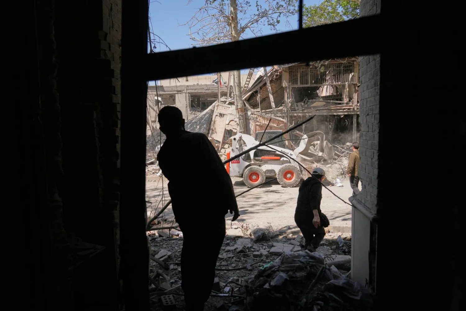 Workers remove debris at Tehran's Sharif University of Technology complex that Iranian authorities say was hit early Monday by a US-Israeli strike, in Tehran, Iran, Monday, April 6, 2026. (AP)
