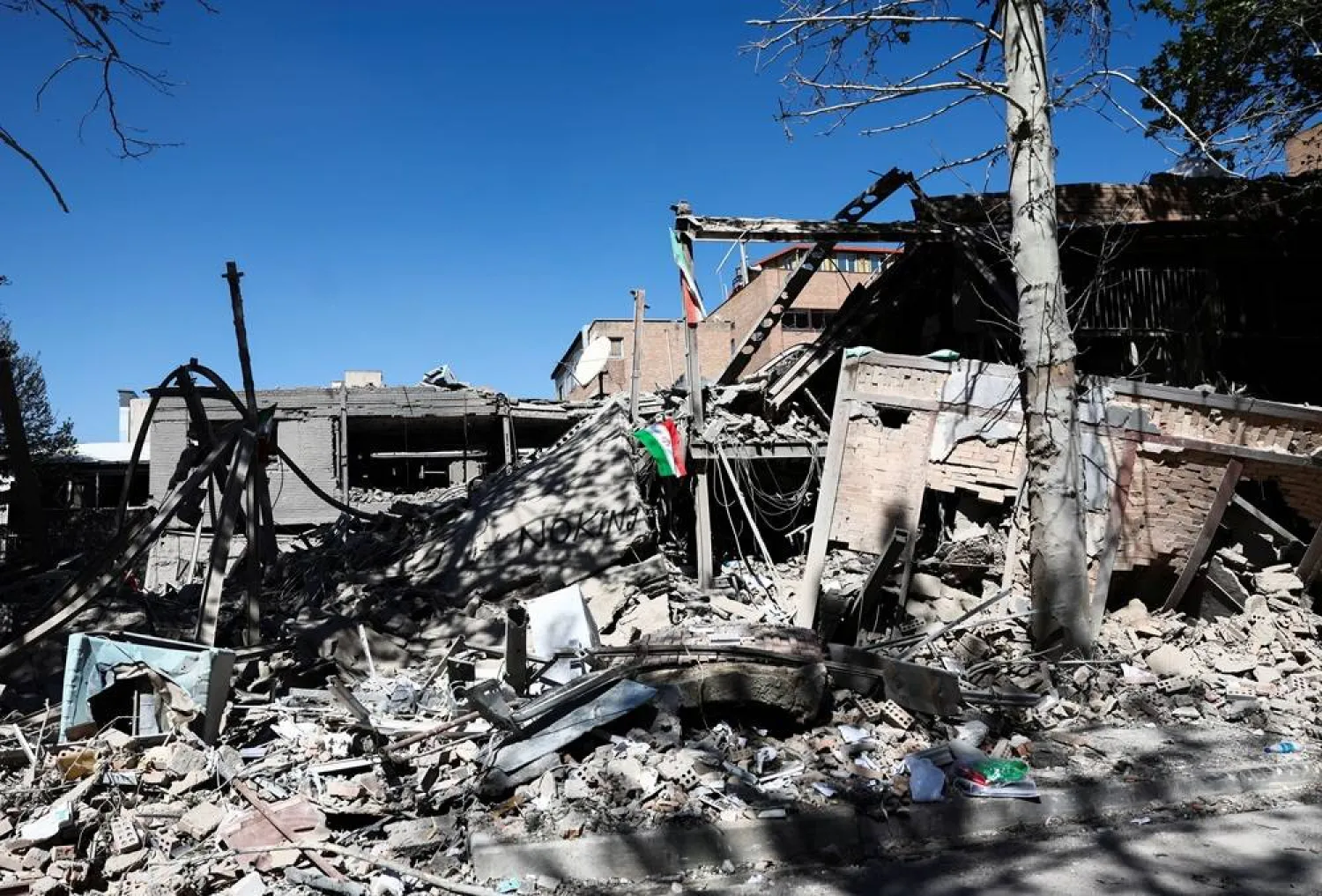 An Iranian flag lies amidst the rubble of a building of the Sharif University of Technology, which was damaged in a strike, amid the US-Israeli conflict with Iran, in Tehran, Iran, April 7, 2026. Majid Asgaripour/WANA (West Asia News Agency) via Reuters