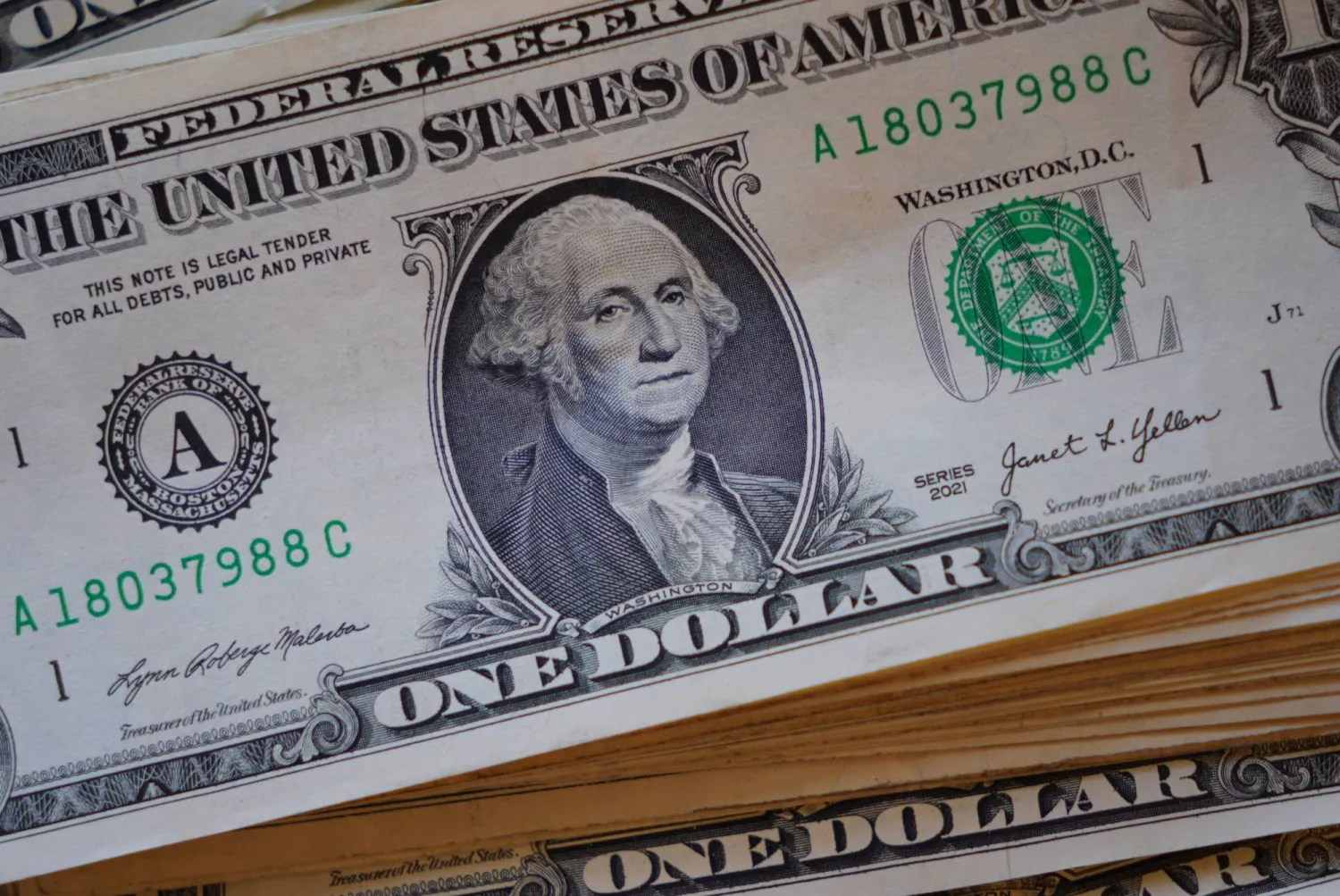 A portrait of George Washington is displayed on a stack of US one-dollar bills in Dallas, Tuesday, April 7, 2026. (AP Photo/LM Otero)
