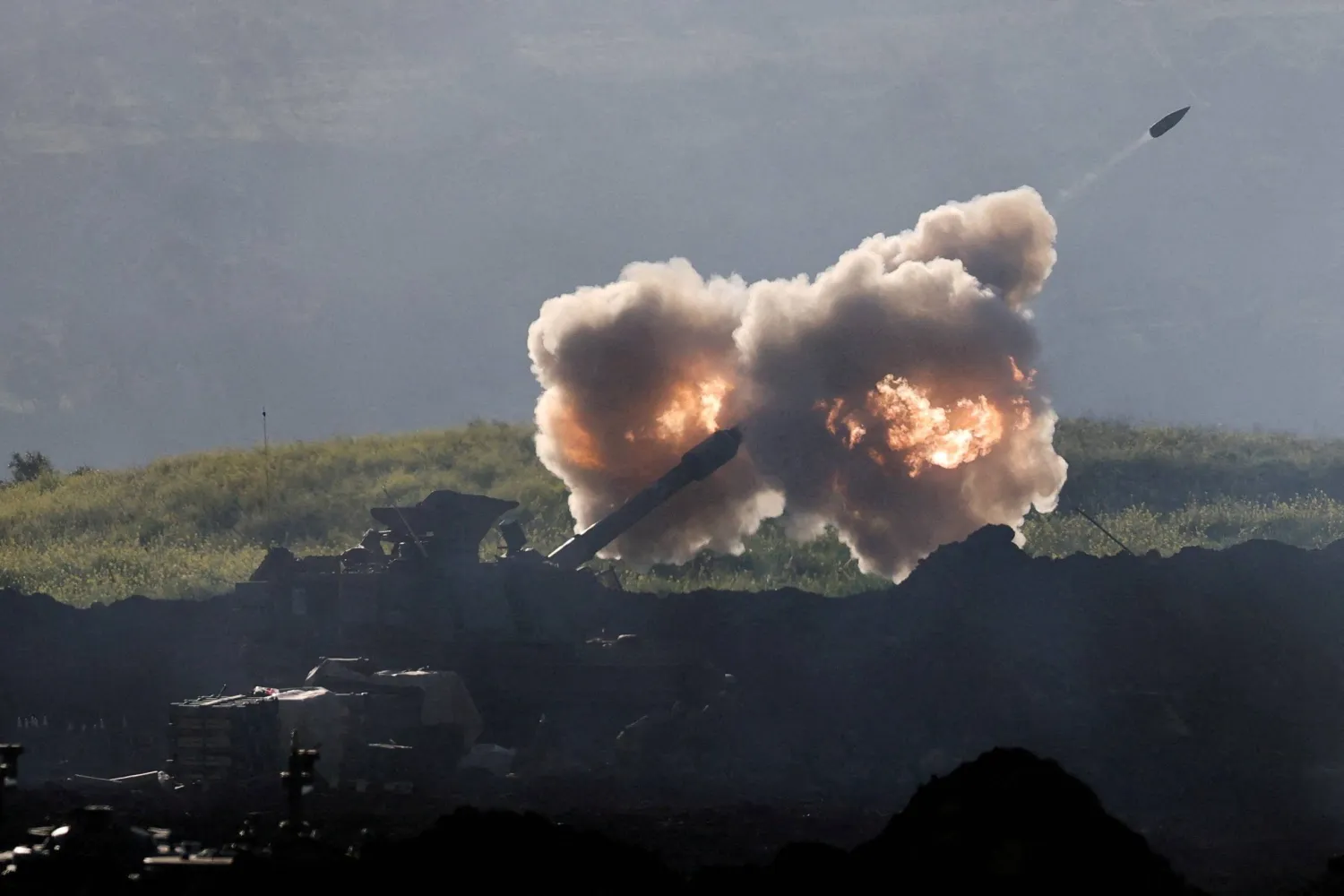 FILE PHOTO: An Israeli artillery unit fires towards Lebanon, on the Israeli side of the Israel-Lebanon border, in northern Israel, March 17, 2026. REUTERS/Ammar Awad/File Photo