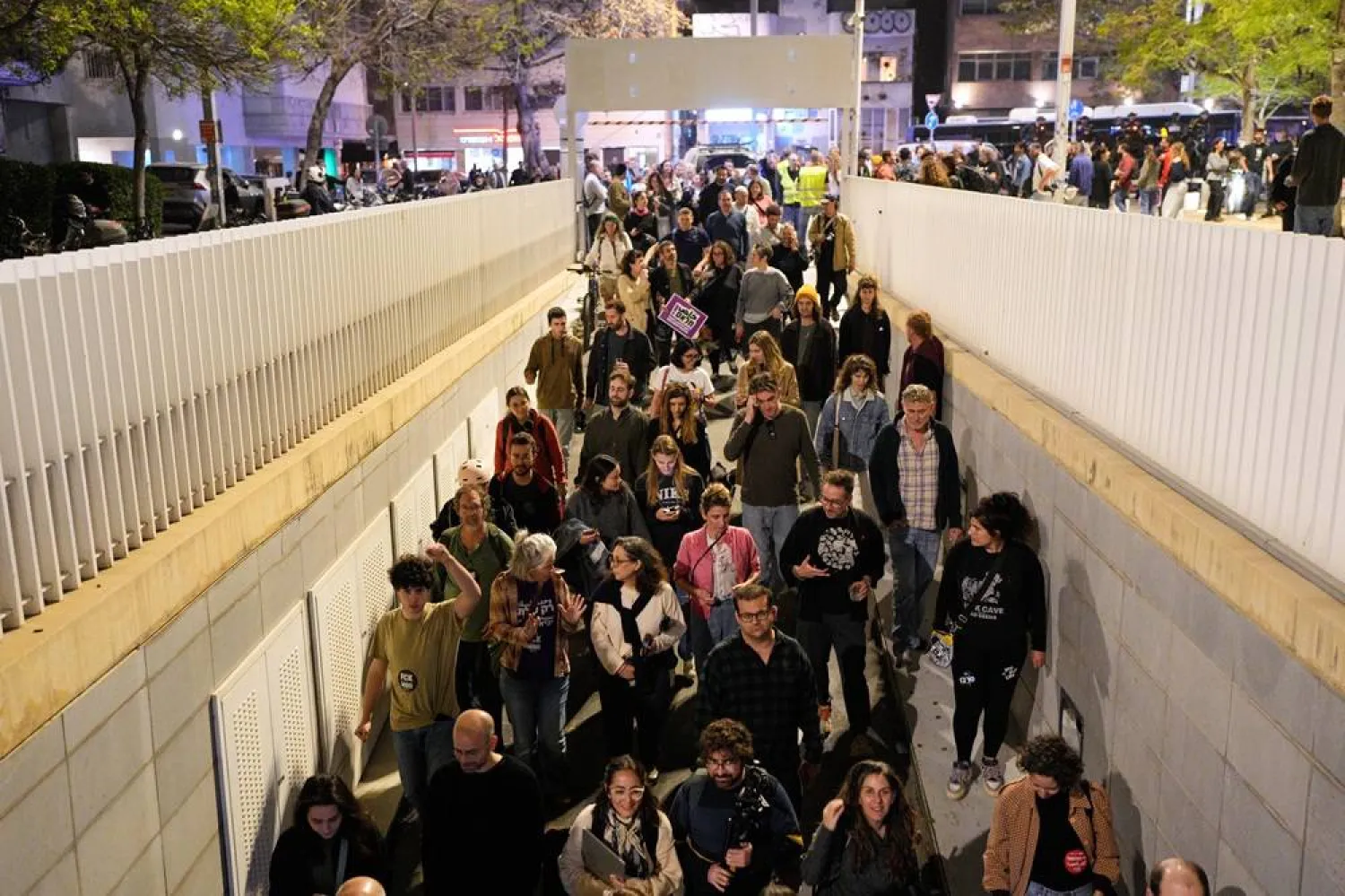  People enter an underground parking garage as sirens warn of an incoming missile fired from Yemen in Tel Aviv, Israel, Saturday, April 4, 2026. (AP) 