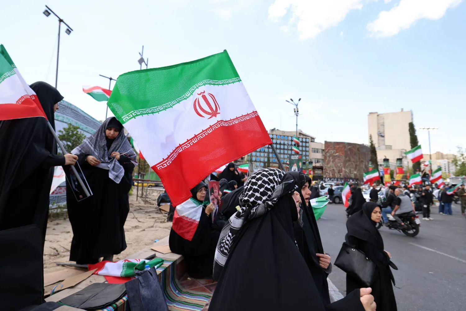 People wave Iranian national flags as they gather at Enghelab Square following the US-Iran ceasefire announcement, in Tehran, Iran, 08 April 2026. EPA/ABEDIN TAHERKENAREH