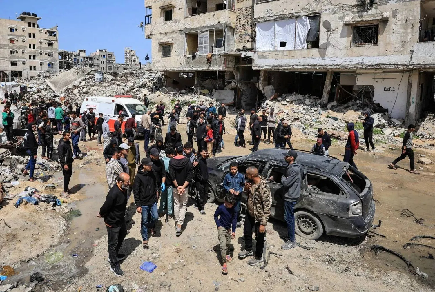 Palestinians inspect damage after an Israeli strike in Gaza City on Monday (Reuters)