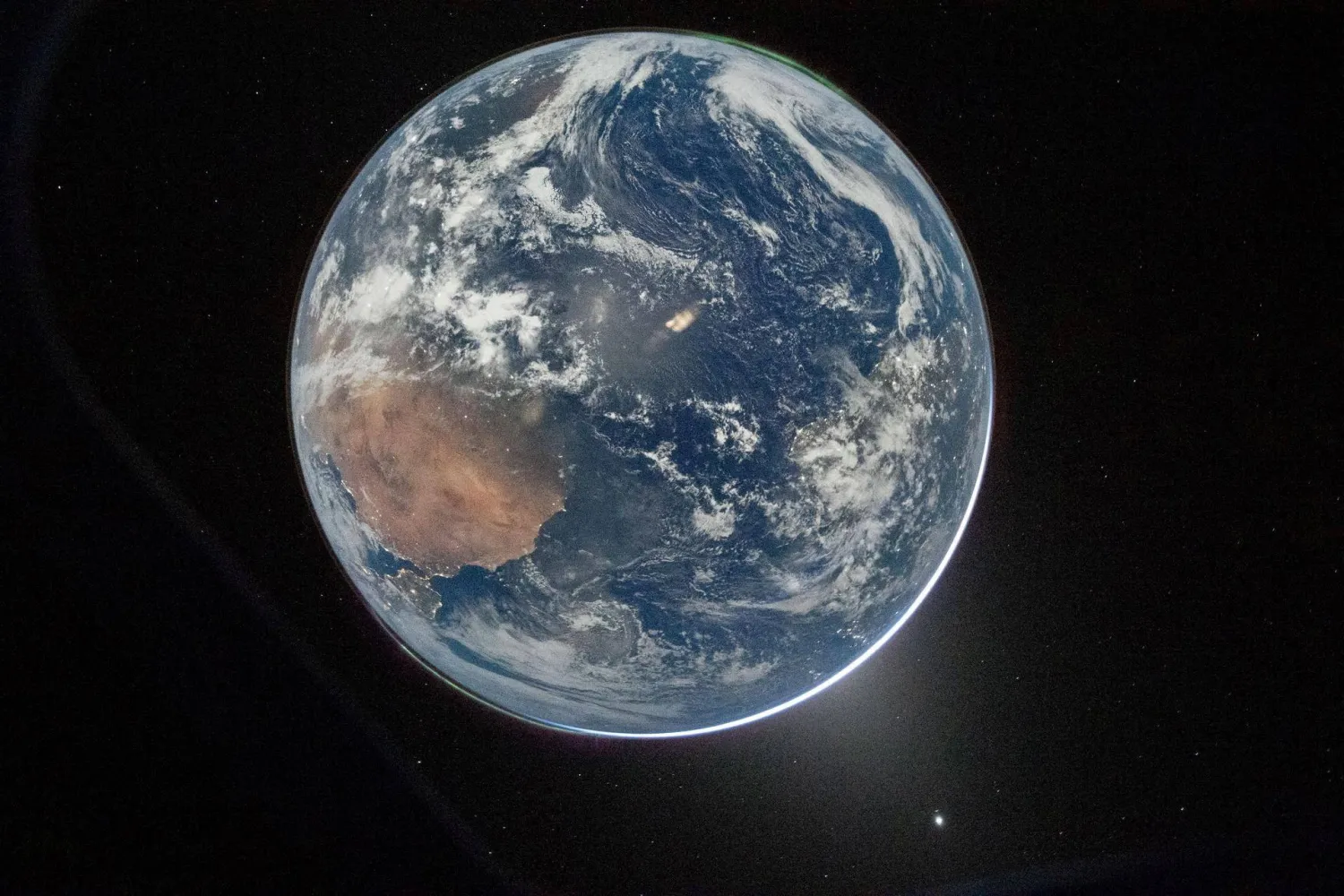 FILE PHOTO: A view of Earth taken by NASA astronaut and Artemis II Commander Reid Wiseman from one of the Orion spacecraft’s window after completing the translunar injection burn on April 2, 2026. NASA/Handout via REUTERS
