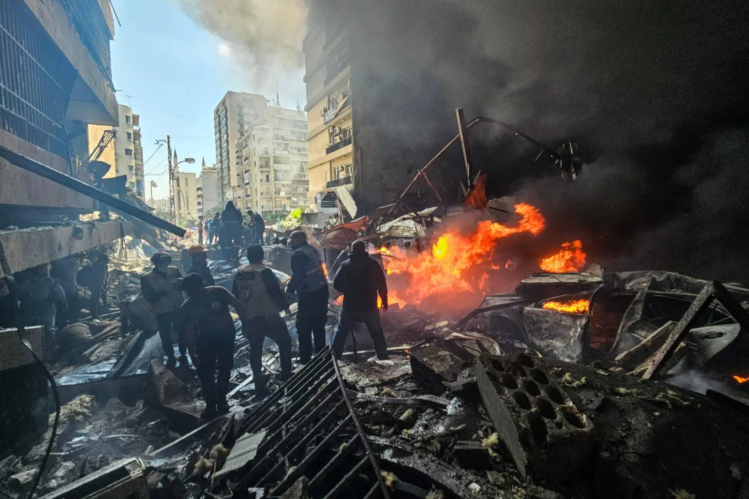 TOPSHOT - First responders stand amid rubble at the site of an Israeli airstrike in Beirut's Corniche al-Mazraa neighborhood on April 8, 2026.  (Photo by AFP)