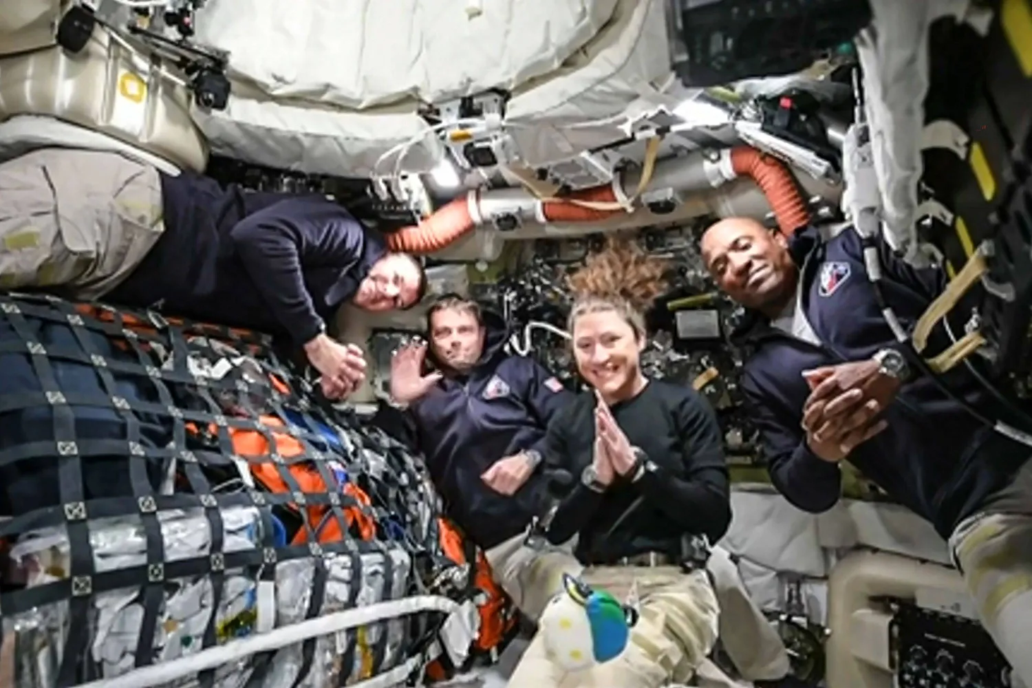 TOPSHOT - This screen grab from NASA's feed released on April 3, 2026, shows the four Artemis II crew members (L-R) Canadian Space Agency (CSA) astronaut Jeremy Hansen, Artemis II mission specialist, NASA astronauts Reid Wiseman, Artemis II commander, Christina Koch, Artemis II mission specialist and Victor Glover, Artemis II pilot as they head to orbit the Moon for the first time in more than half a century. The spacecraft lifted off from Kennedy Space Center in Florida at 18:35 EDT the previous day. (Photo by Handout / NASA TV / AFP)  