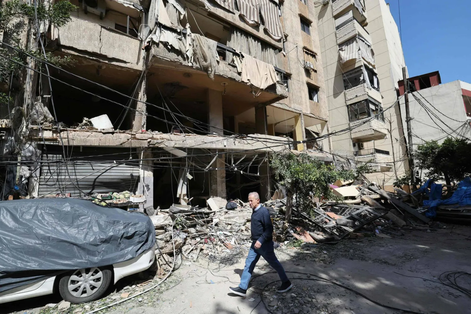 A Lebanese man walks past destruction at the site of an Israeli airstrike the day before that targeted a building in Beirut on April 9, 2026. (Photo by Ibrahim AMRO / AFP)