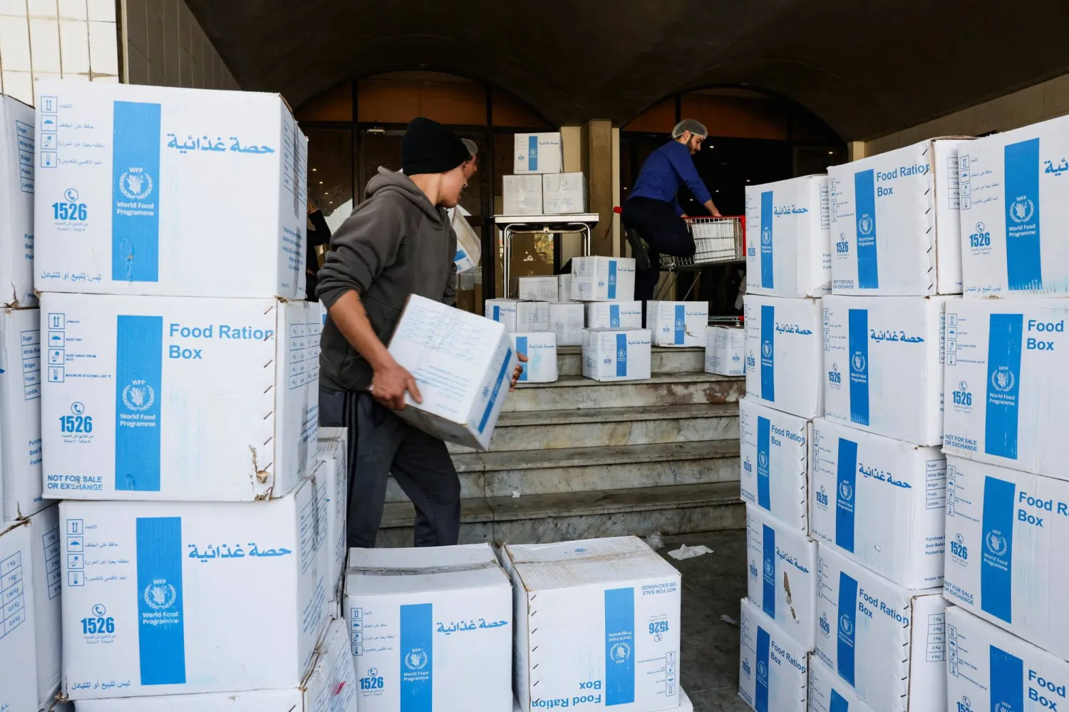 Volunteers carry World Food Program (WFP) boxes of aid supplies in a school-turned-shelter in Beirut, following an escalation between Hezbollah and Israel amid the US-Israeli conflict with Iran, Lebanon, March 12, 2026. REUTERS/Mohamed Azakir