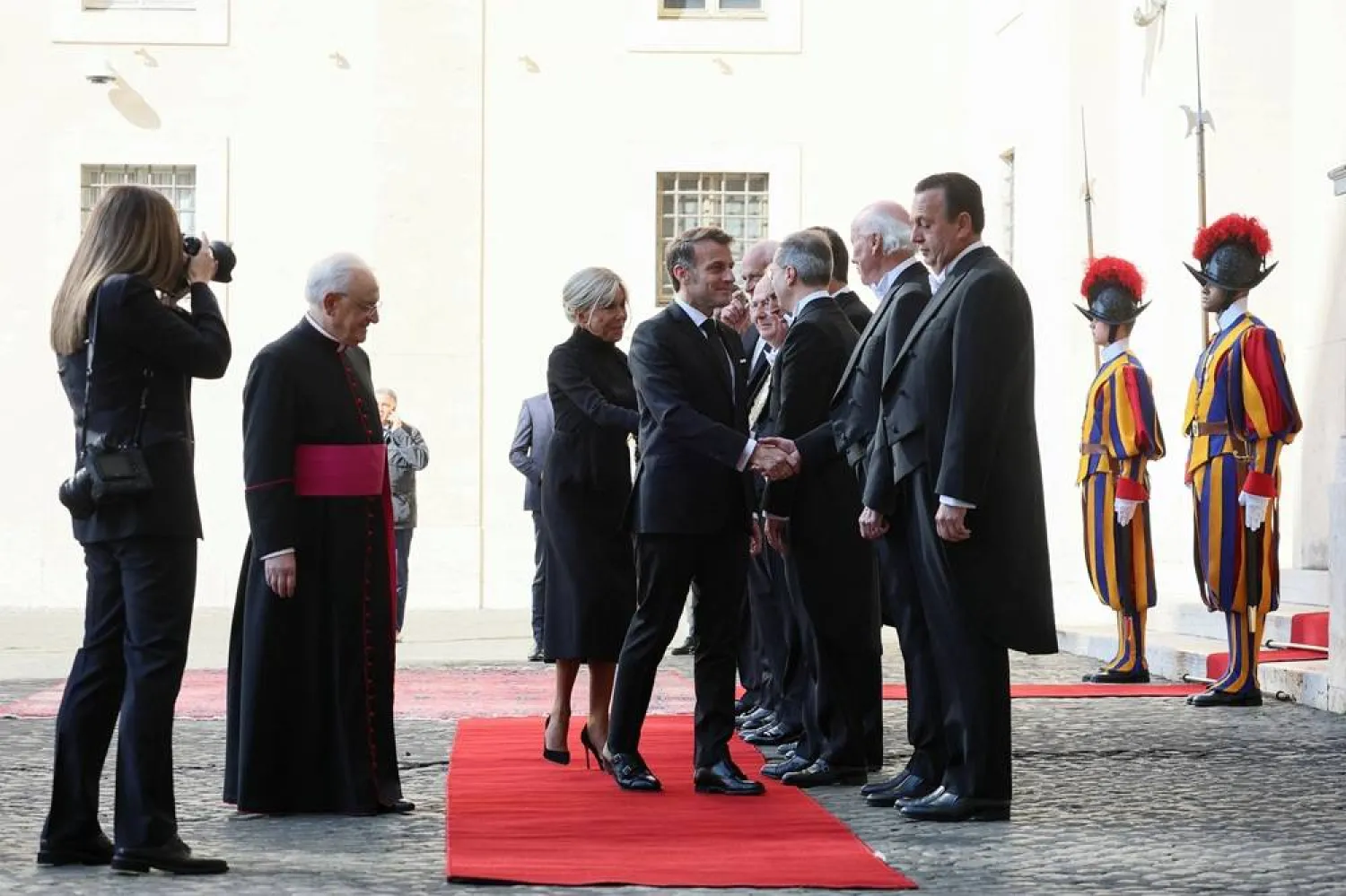  French President Emmanuel Macron and his wife Brigitte Macron are welcomed as they arrive at the San Damaso courtyard to meet Pope Leo XIV at the Vatican, April 10, 2026. (Reuters)