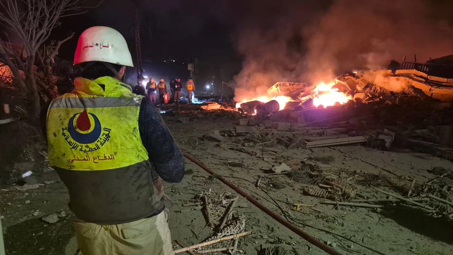 First responders gather at the site of an Israeli airstrike in the village of Habbouch, southern Lebanon on April 10, 2026. (Photo by Abbas FAKIH / AFP)