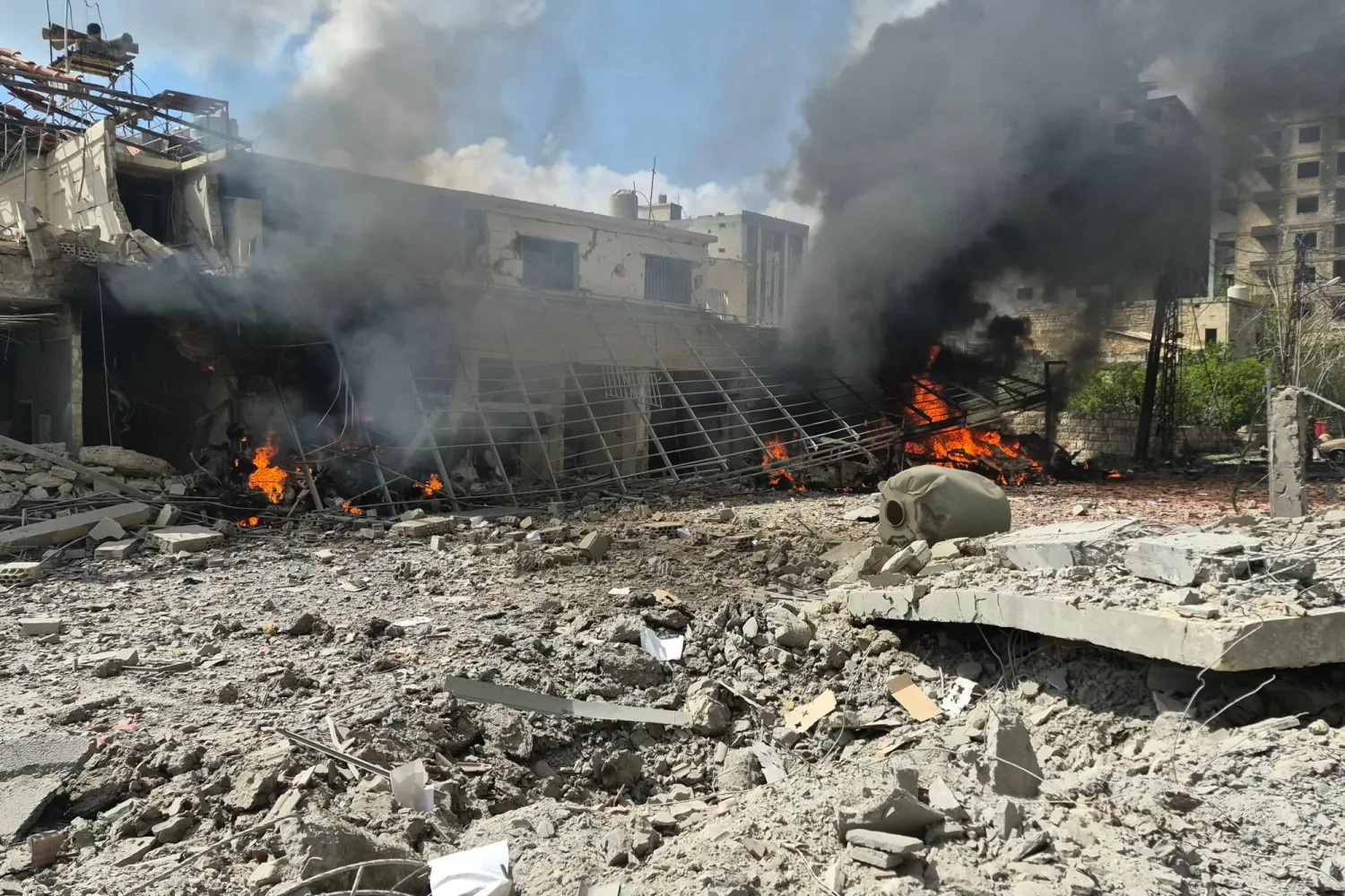 Flames and smoke engulf part of the site of an Israeli airstrike that targeted the Lebanese State Security Center, in the Southern Lebanese city of Nabatieh on April 10 2026. (AFP)
