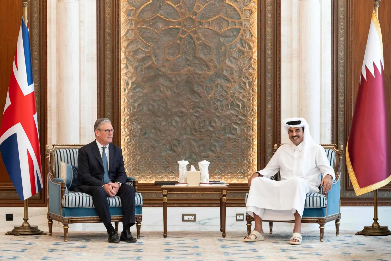 This handout photograph taken and released by Qatar's Amiri Diwan shows Qatar's Emir Sheikh Tamim bin Hamad Al-Thani meeting with British Prime Minister Keir Starmer (L) at Lusail Palace on April 10, 2026. (Qatar's Amiri Diwan / AFP)  