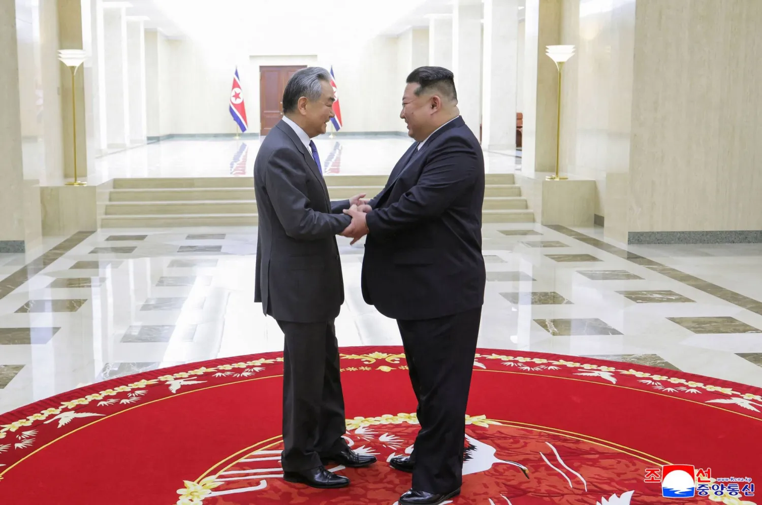 This picture taken on April 10, 2026 and released by North Korea's official Korean Central News Agency (KCNA) on April 11, 2026, shows Chinese Foreign Minister Wang Yi (L) shaking hands with North Korean leader Kim Jong Un at the headquarters of the Workers' Party of Korea in Pyongyang.  (KCNA / KCNA via KNS / AFP) 