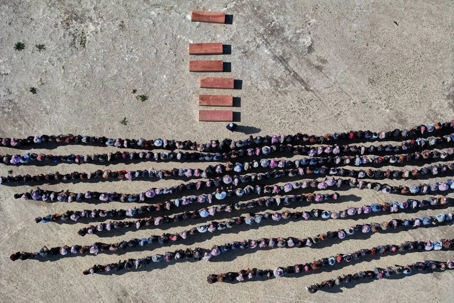  Mourners pray over the six coffins of members of the al-Jalib family, who were killed Wednesday in Israeli strikes in Beirut, during their funeral in the village of al-Sour, Deir Ezzor province, northeastern Syria, Saturday, April 11, 2026. (AP) 