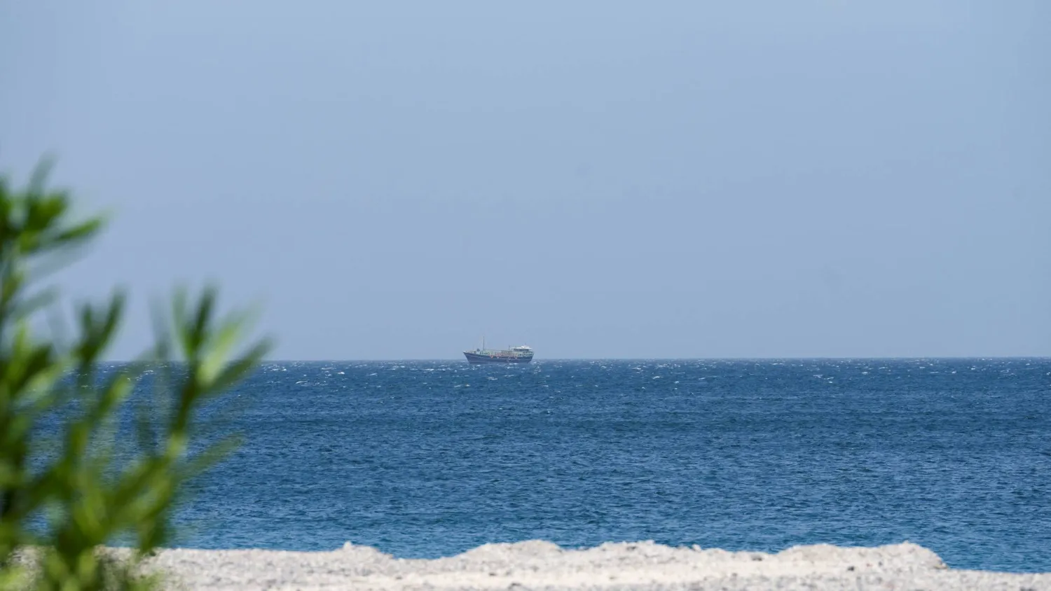 A boat is off the coast of Musandam governorate, overlooking the strait of Hormuz, in Musandam governance, in Oman, April 8, 2026. (Reuters)