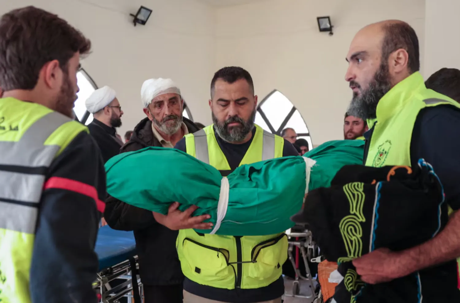 A member of civil defense personnel holds the body of Taleen Saeed, 1.5 years old, killed in an Israeli strike in the village of Srifa, at the Al Kharab mosque in Tyre, Lebanon, April 12, 2026. REUTERS
