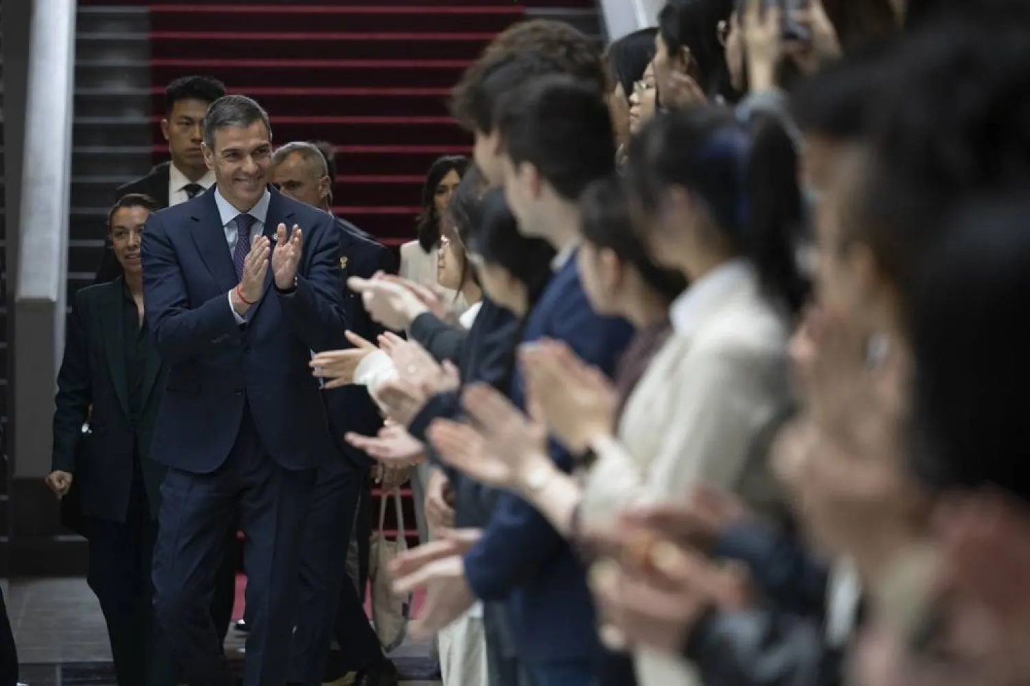 Spanish Prime Minister Pedro Sanchez arrives for a group photo with students at Tsinghua University in Beijing, China, 13 April 2026. (EPA)