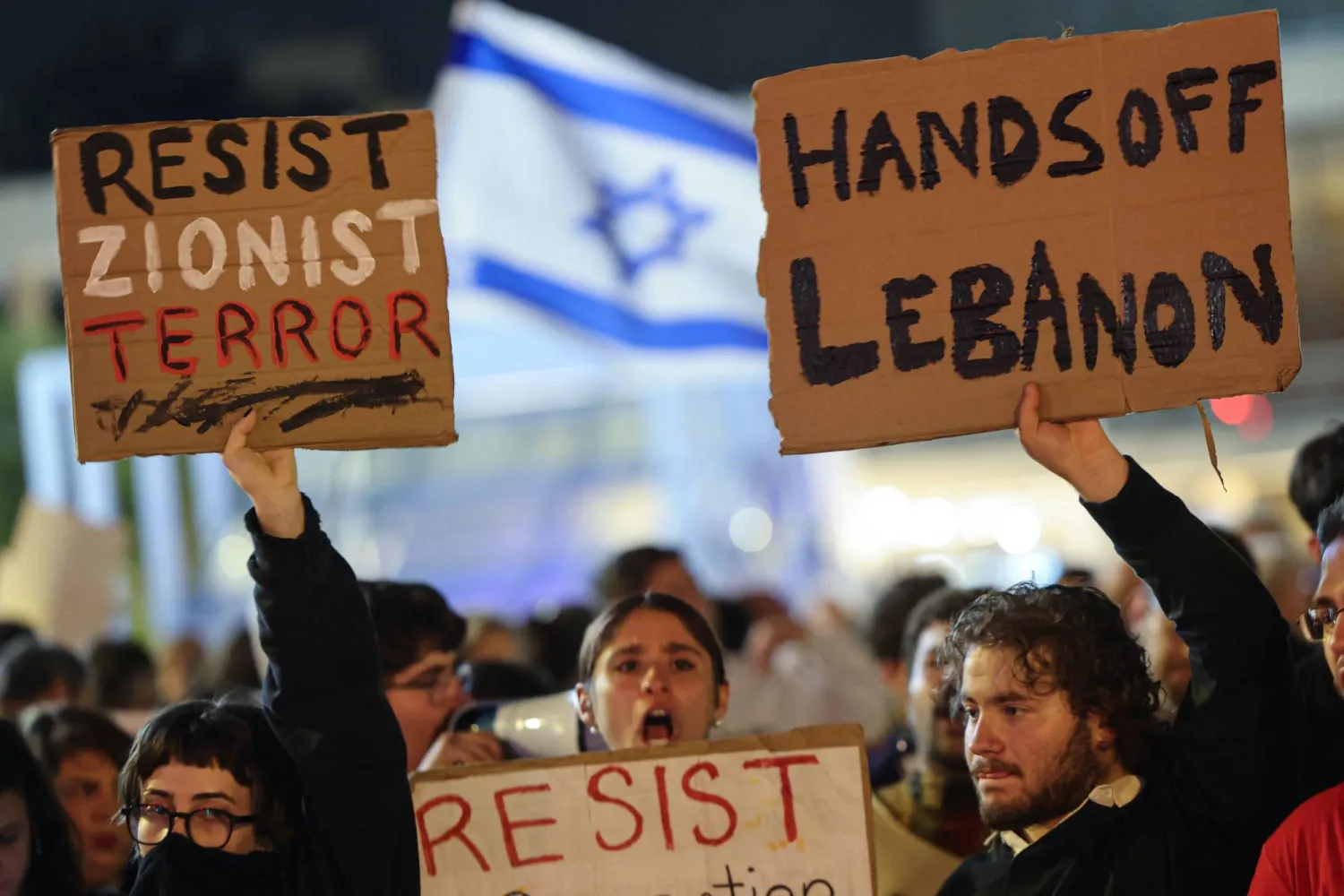 Israeli left-wing activists demonstrate with placards in HaBima Square against the ongoing war with Iran and against the Israeli government in Tel Aviv on April 11, 2026. (AFP)