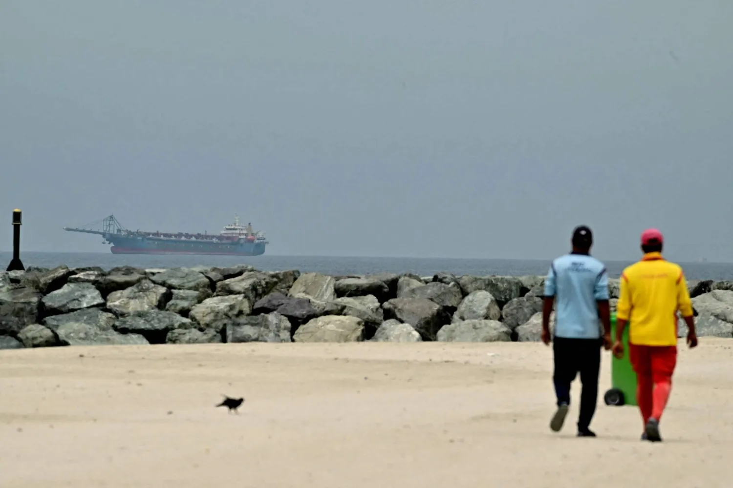 A ship is seen in the Gulf off the coast of Sharjah the day after the failure of US-Iran peace talks on April 13, 2026. (AFP)