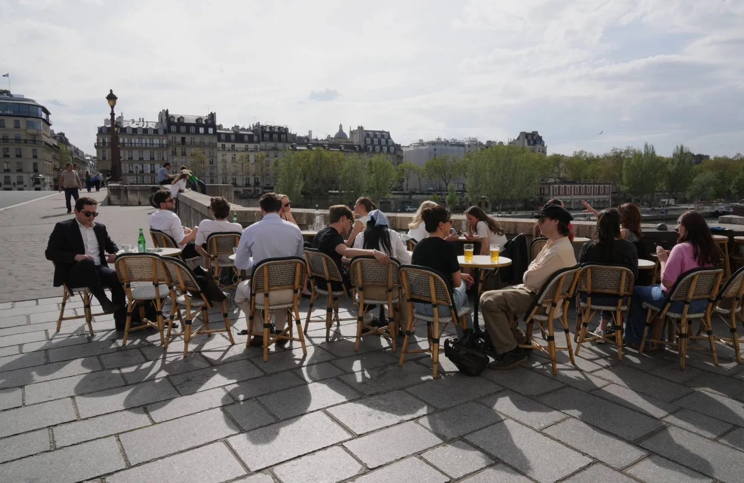 People sit at a bistro, enjoying the sun in Paris, Thursday, April 9, 2026.(AP Photo/Michel Euler)