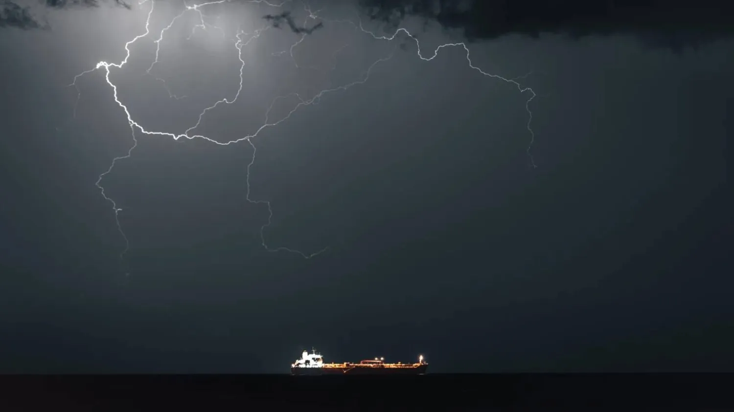 Lightning occurs when META 4, an Oil Products Tanker, sails into Muscat Anchorage on March 21, 2026 at Sultan Qaboos Port in Muscat, Oman (Getty)