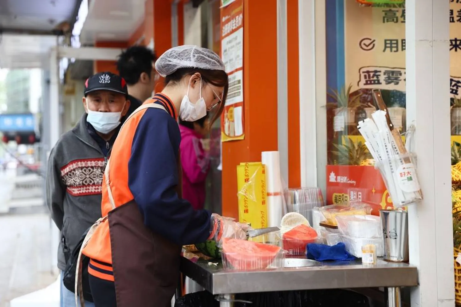 A staff works in front of a fruit shop in Beijing, China, 14 April 2026. (EPA)