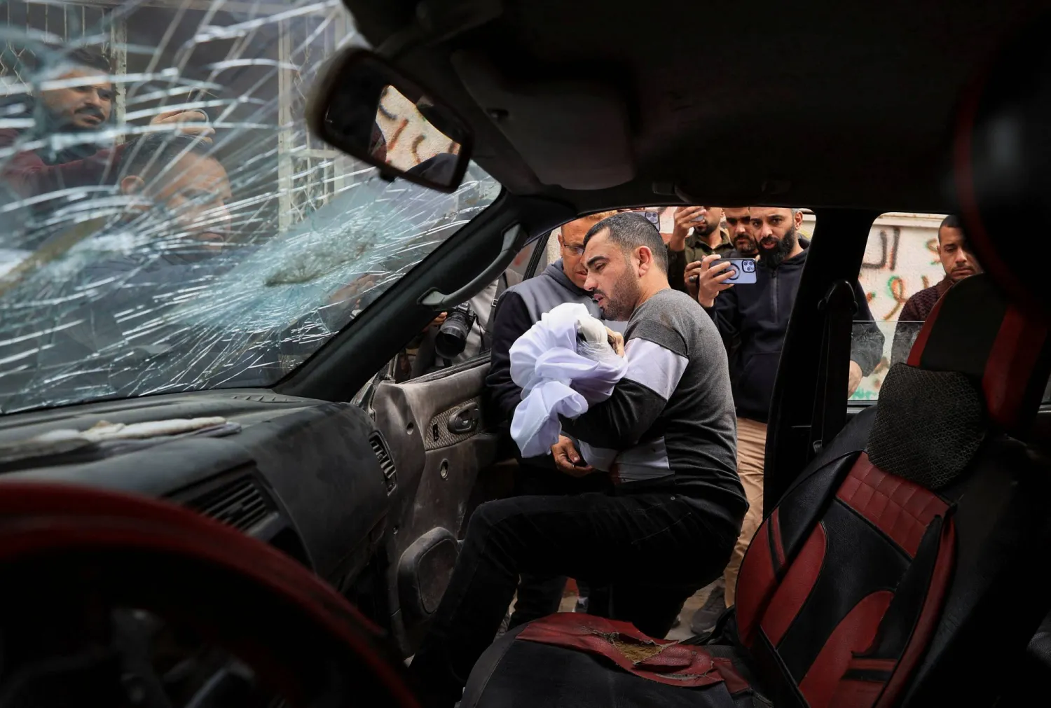 A father holds the body of his three‑year‑old child, Yahya Al‑Malahi, who was killed in an Israeli strike, according to medics, during his funeral in Gaza City, April 14, 2026. (Reuters)