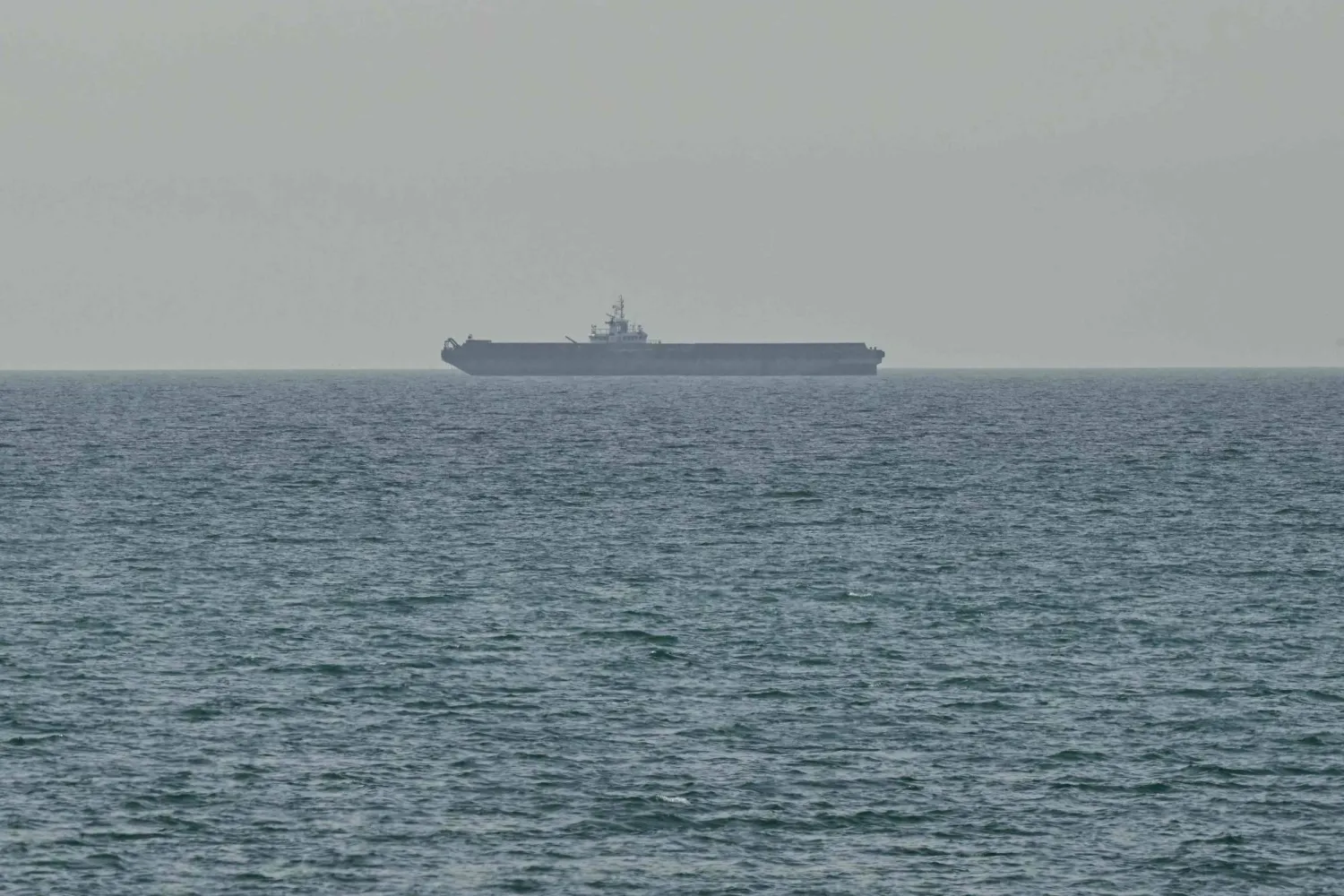 A ship is seen off the coast of Ras al-Khaimah, the day after the failure of US-Iran peace talks on April 13, 2026. (AFP)