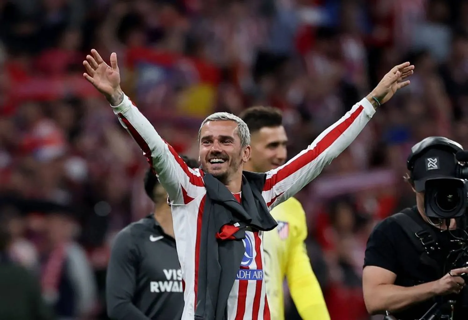 Atletico Madrid's French forward #07 Antoine Griezmann and teammates celebrate at the end of the UEFA Champions League quarter-final second leg football match between Club Atletico de Madrid and FC Barcelona at Metropolitano Stadium in Madrid on April 14, 2026. (AFP)