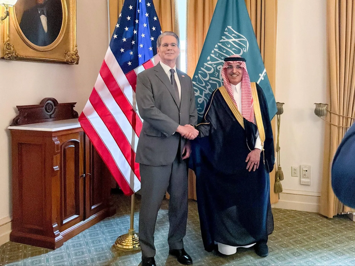 Al-Jadaan and Bessent shake hands after signing the Tax Information Exchange Agreement in Washington. (X)