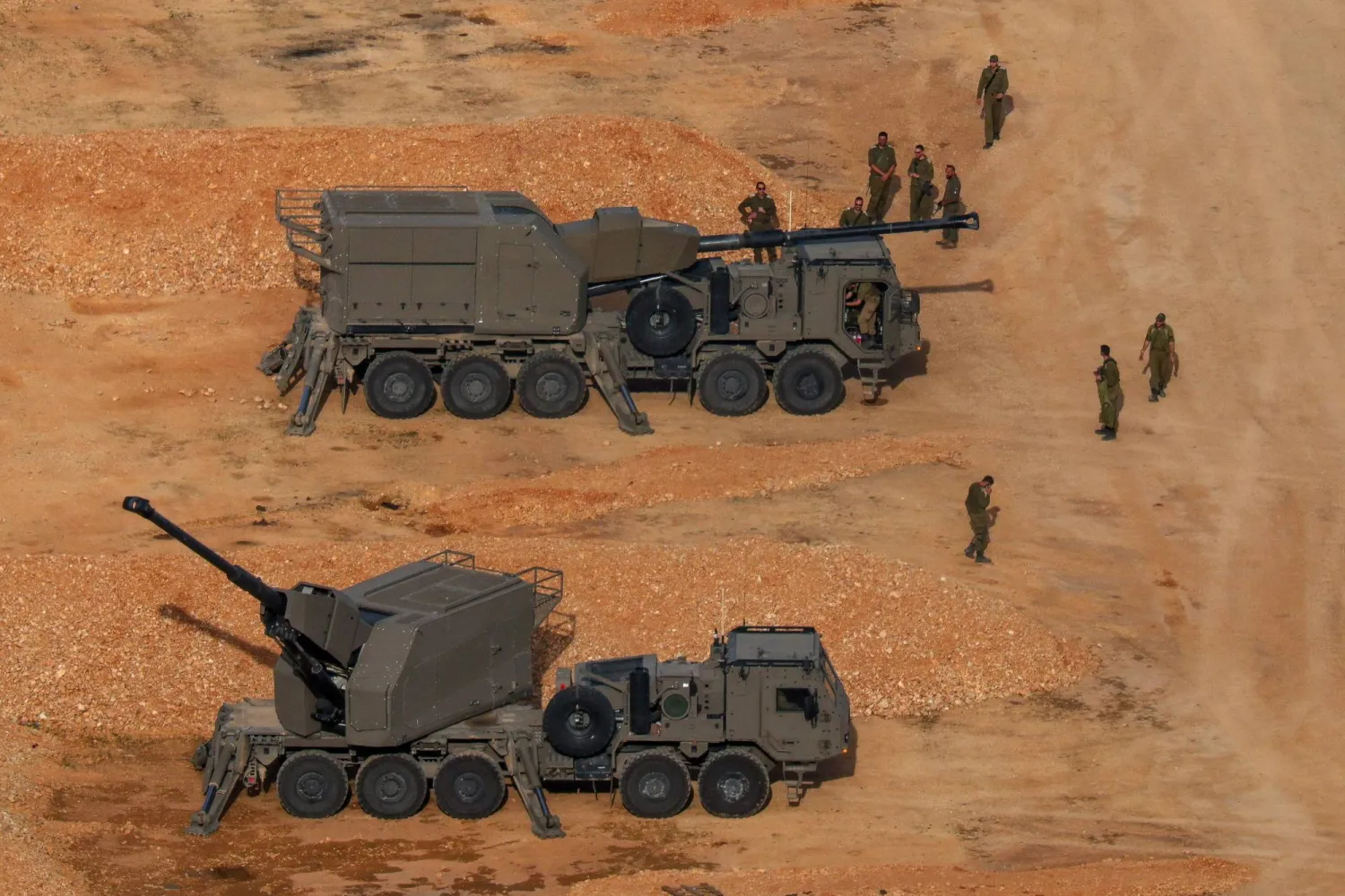 Israeli soldiers next to artillery vehicles near the Israel-Lebanon border, in northern Israel, April 15, 2026. (Reuters) 