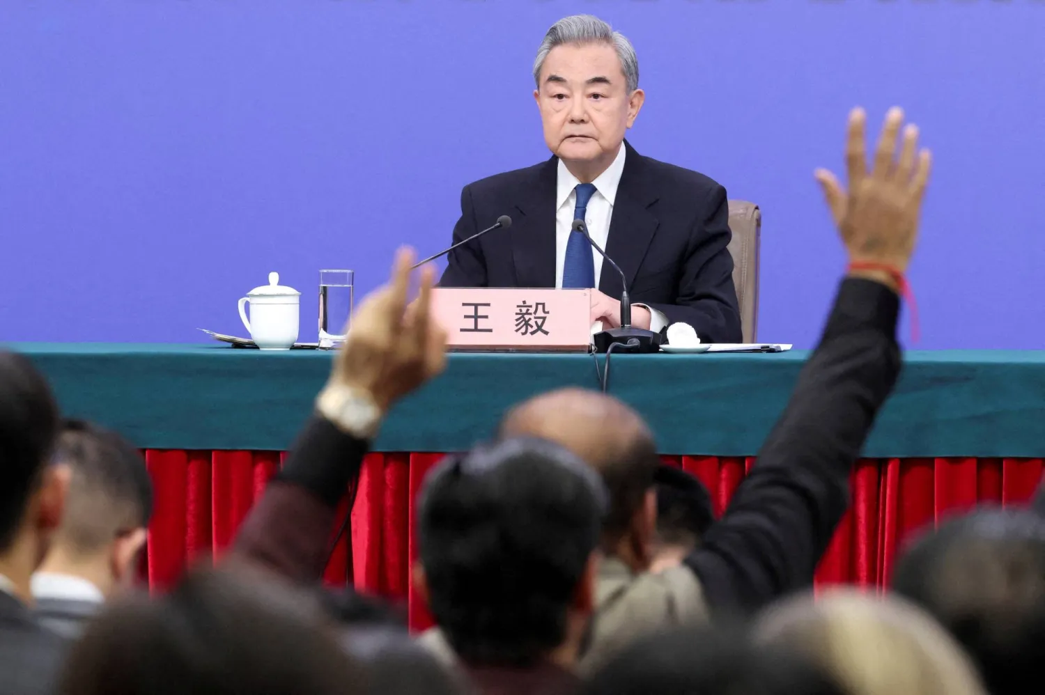 Members of the media raise hands to ask questions as Chinese Foreign Minister Wang Yi holds a press conference on the sidelines of the National People's Congress (NPC), in Beijing, China, March 8, 2026. (Reuters)