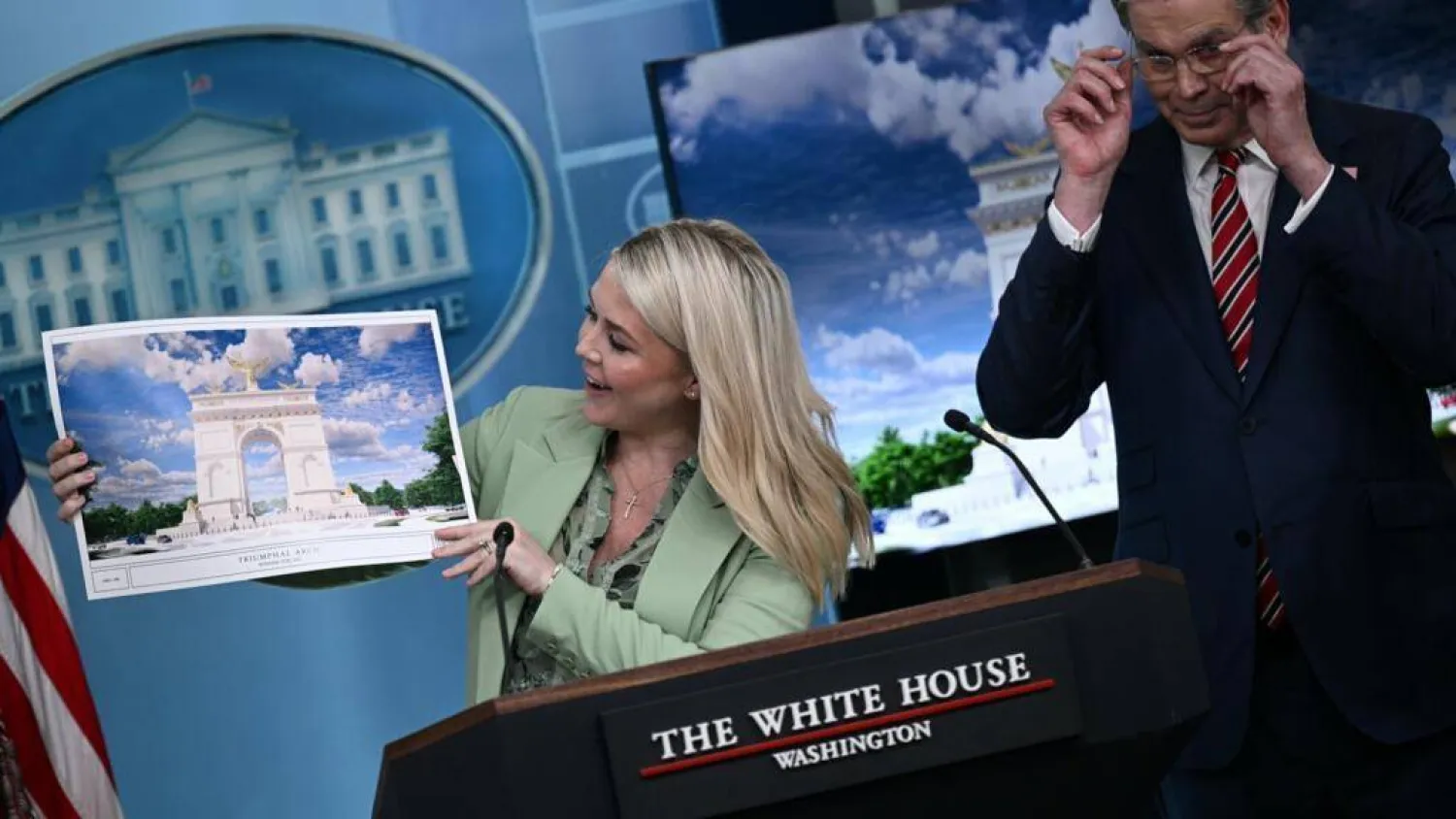 White House Press Secretary Karoline Leavitt shows off an artist's rendering of President Donald Trump's planned Triumphal Arch. Brendan SMIALOWSKI / AFP
