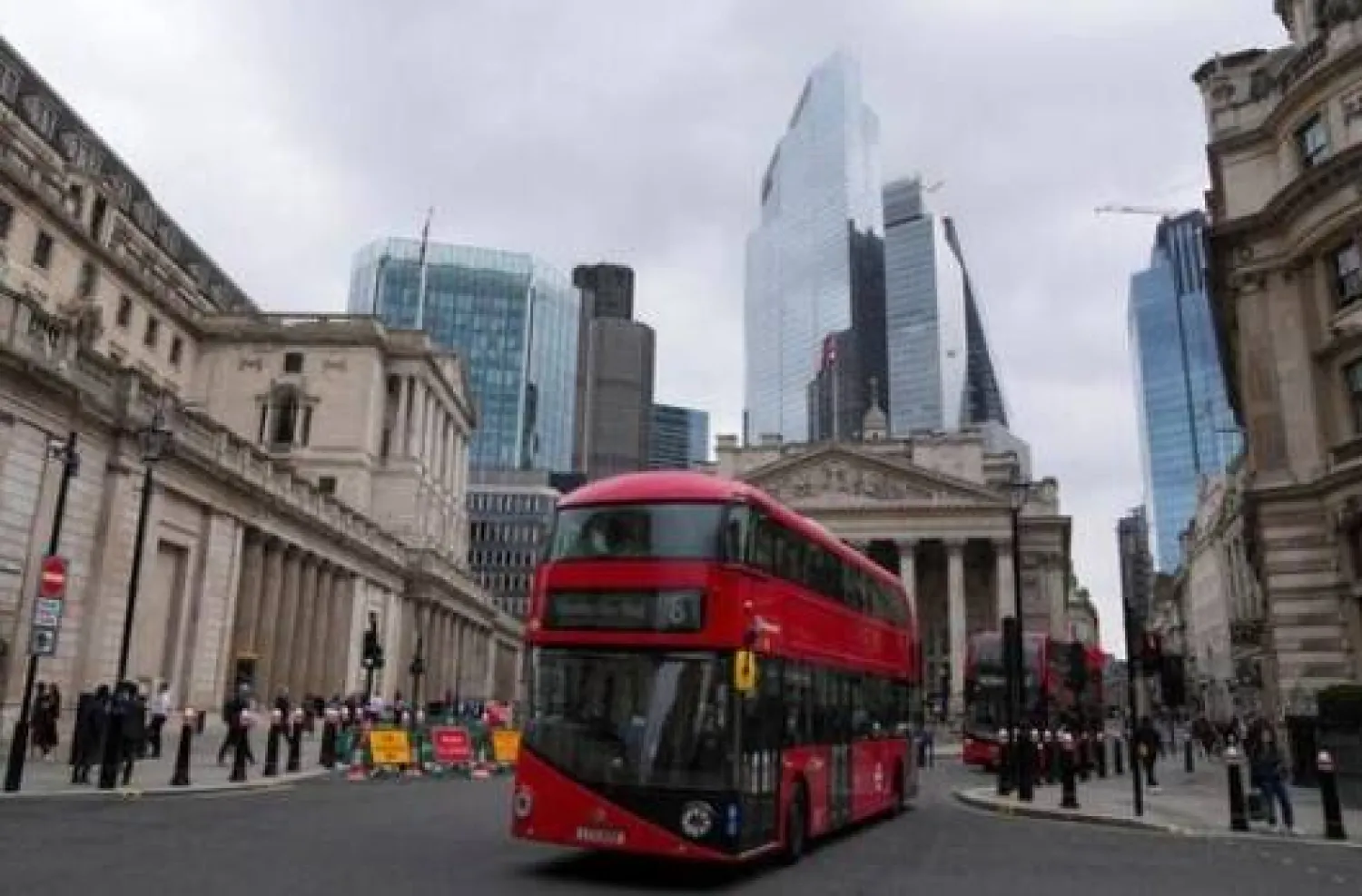 Buses pass in front of the Bank of England building in London (Reuters)