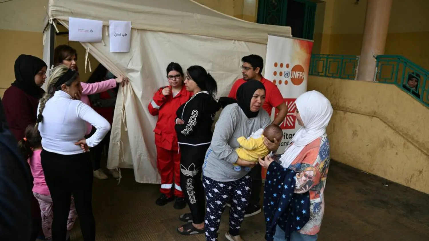 Mariam Zein (R) brings her son to a mobile health clinic run by charity Caritas Lebanon. Joseph EID / AFP
