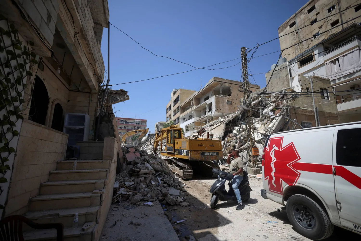 A man next to an ambulance looks at the site of an Israeli strike carried out before a 10-day ceasefire between Lebanon and Israel went into effect, in Tyre, Lebanon, April 17, 2026. REUTERS/Louisa Gouliamaki     