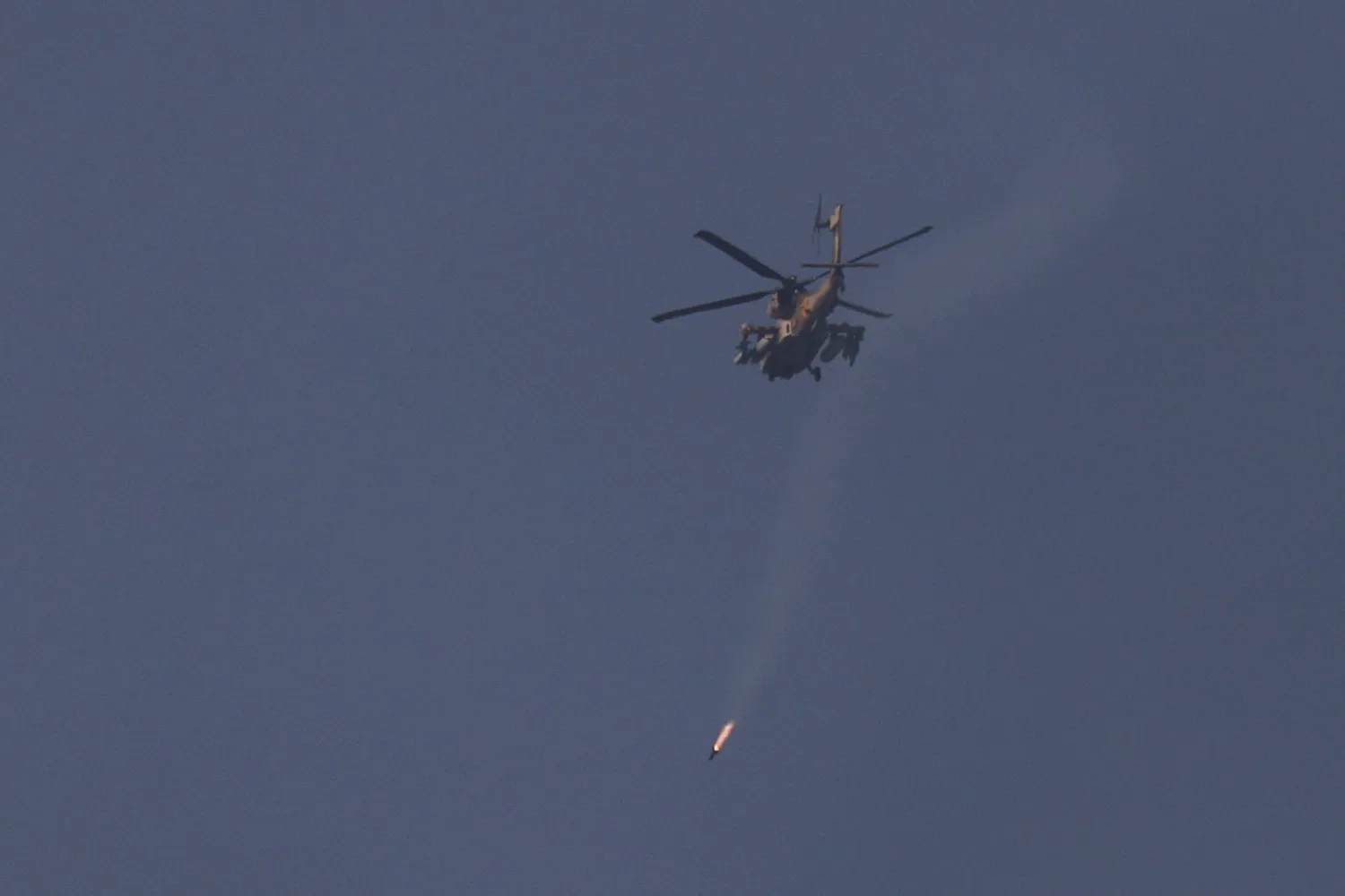  An Israeli helicopter fires a projectile, as it flies over Lebanon, after a 10-day ceasefire between Lebanon and Israel went into effect, as seen from Israel, April 17, 2026. (Reuters)