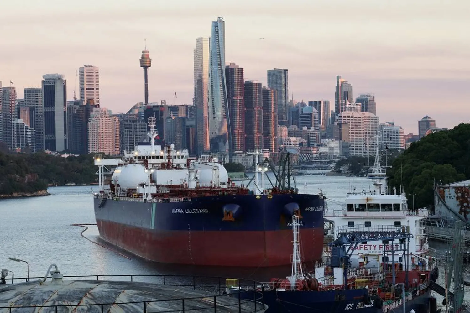 Hafnia Lillesand, a crude oil and product tanker, sits at Viva Energy Australia's Gore Bay fuel terminal overlooking the city skyline in Sydney, Australia April 14, 2026. (Reuters)