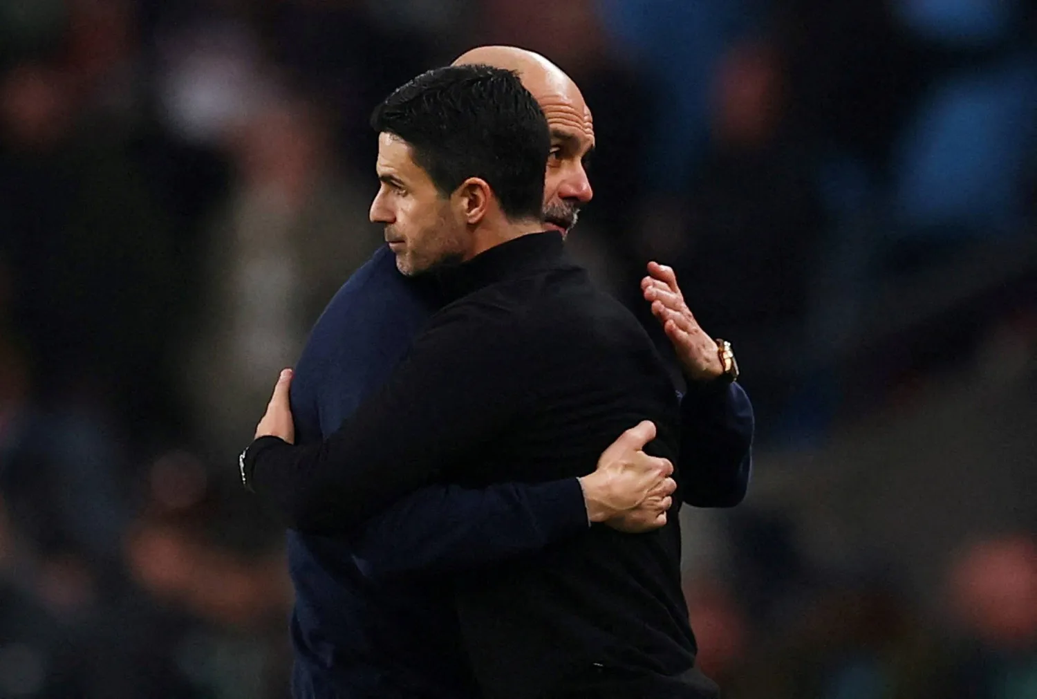 Football - Carabao Cup - Final - Arsenal v Manchester City - Wembley Stadium, London, Britain - March 22, 2026 Manchester City manager Pep Guardiola embraces Arsenal manager Mikel Arteta after winning the Carabao Cup. (Action Images via Reuters) 