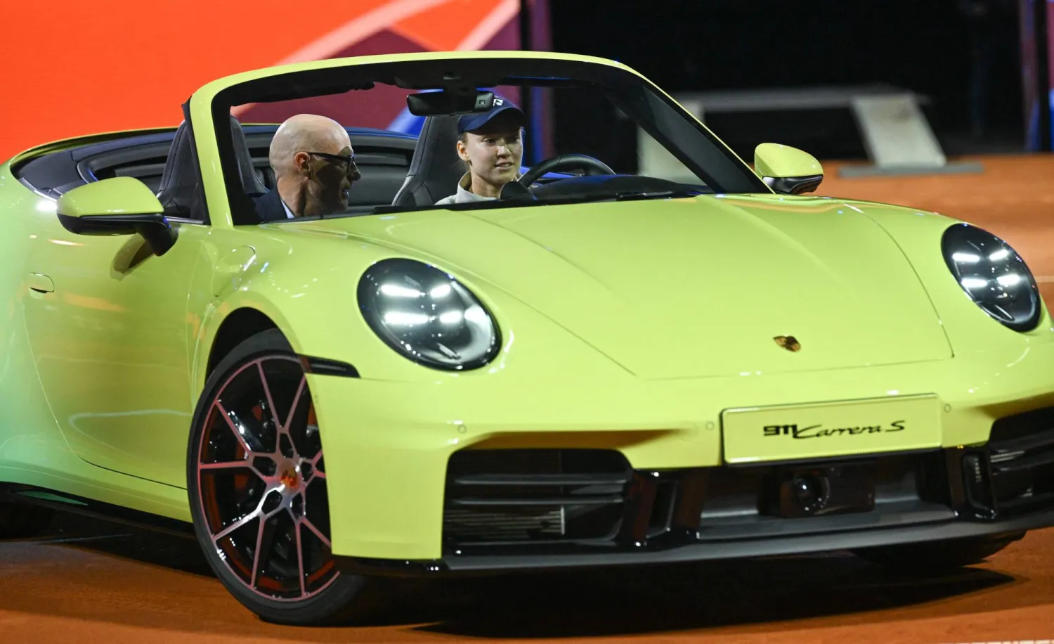  Kazakhstan's Elena Rybakina steers the winner's car next to Porsche CEO Michael Leiters after she won against Czech Republic's Karolina Muchova (not in picture) in the final match at the Women's Tennis Grand Prix WTA tournament in Stuttgart, southwestern Germany, on April 19, 2026. (AFP) 