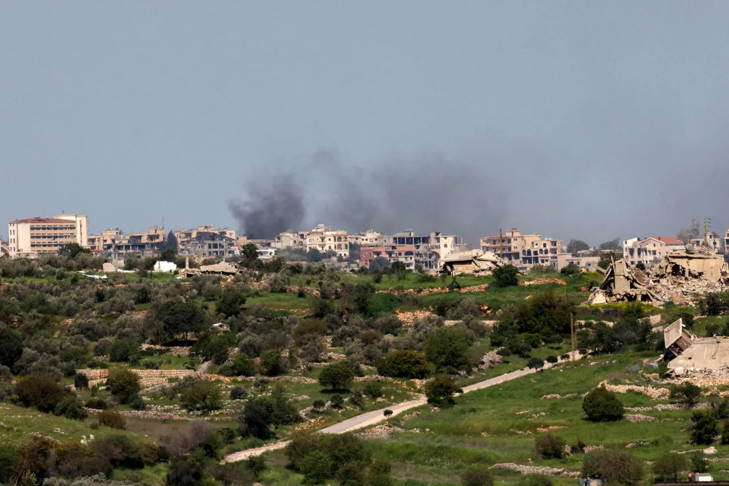 Smoke rises over the southern Lebanese village of Bint Jbeil near the border as seen from the Upper Galilee in northern Israel, on April 17, 2026. (AFP)