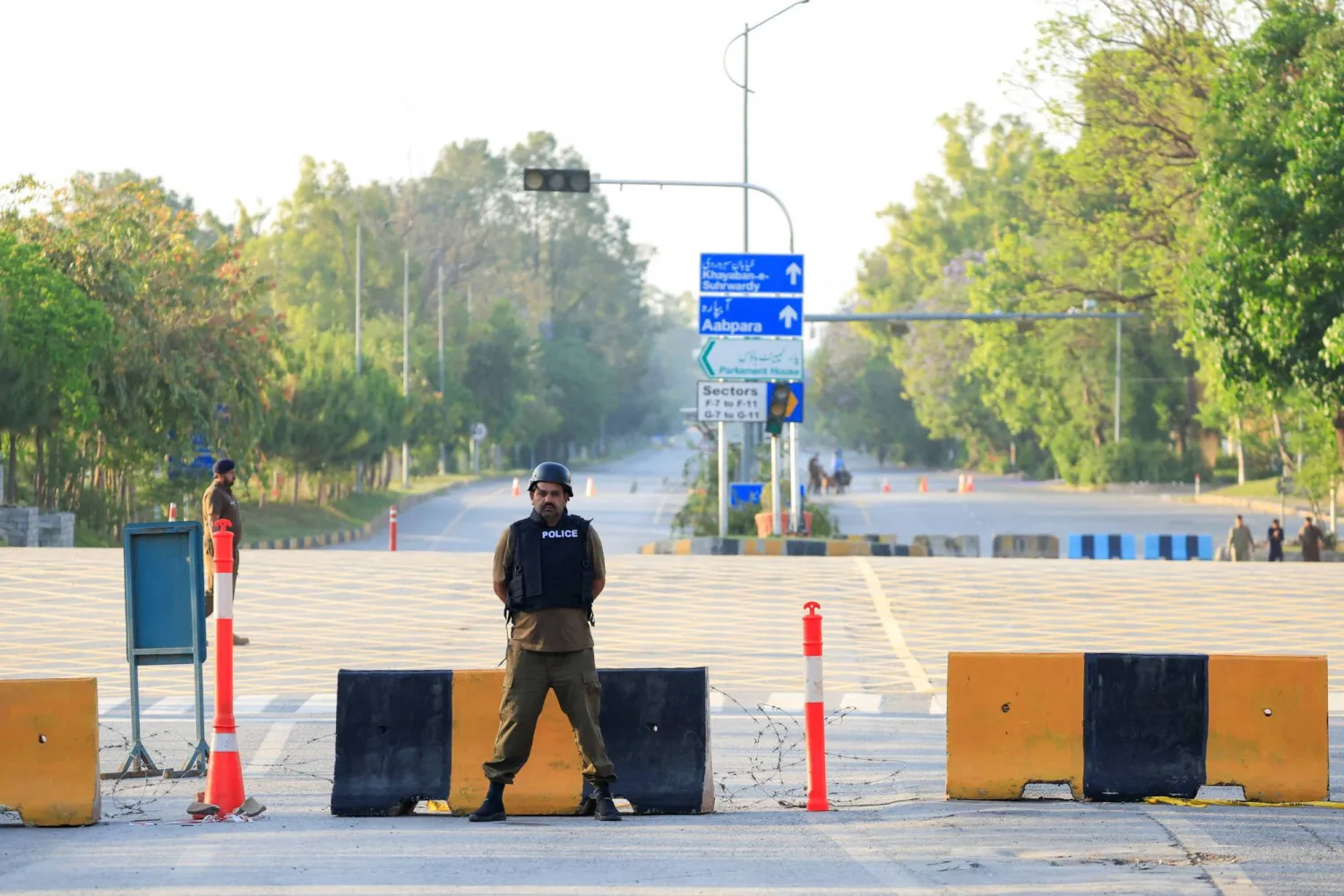  Police officers stand guard on a road leading to the Serena Hotel, as Pakistan prepares to host the US and Iran for the second phase of peace talks in Islamabad, Pakistan, April 21, 2026. (Reuters)