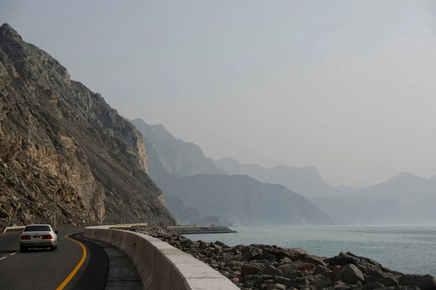 FILE PHOTO: A car rides along the coast of Musandam overlooking the Strait of Hormuz amid the US-Israeli conflict with Iran, Oman, March 2, 2026.REUTERS/Amr Alfiky/File Photo