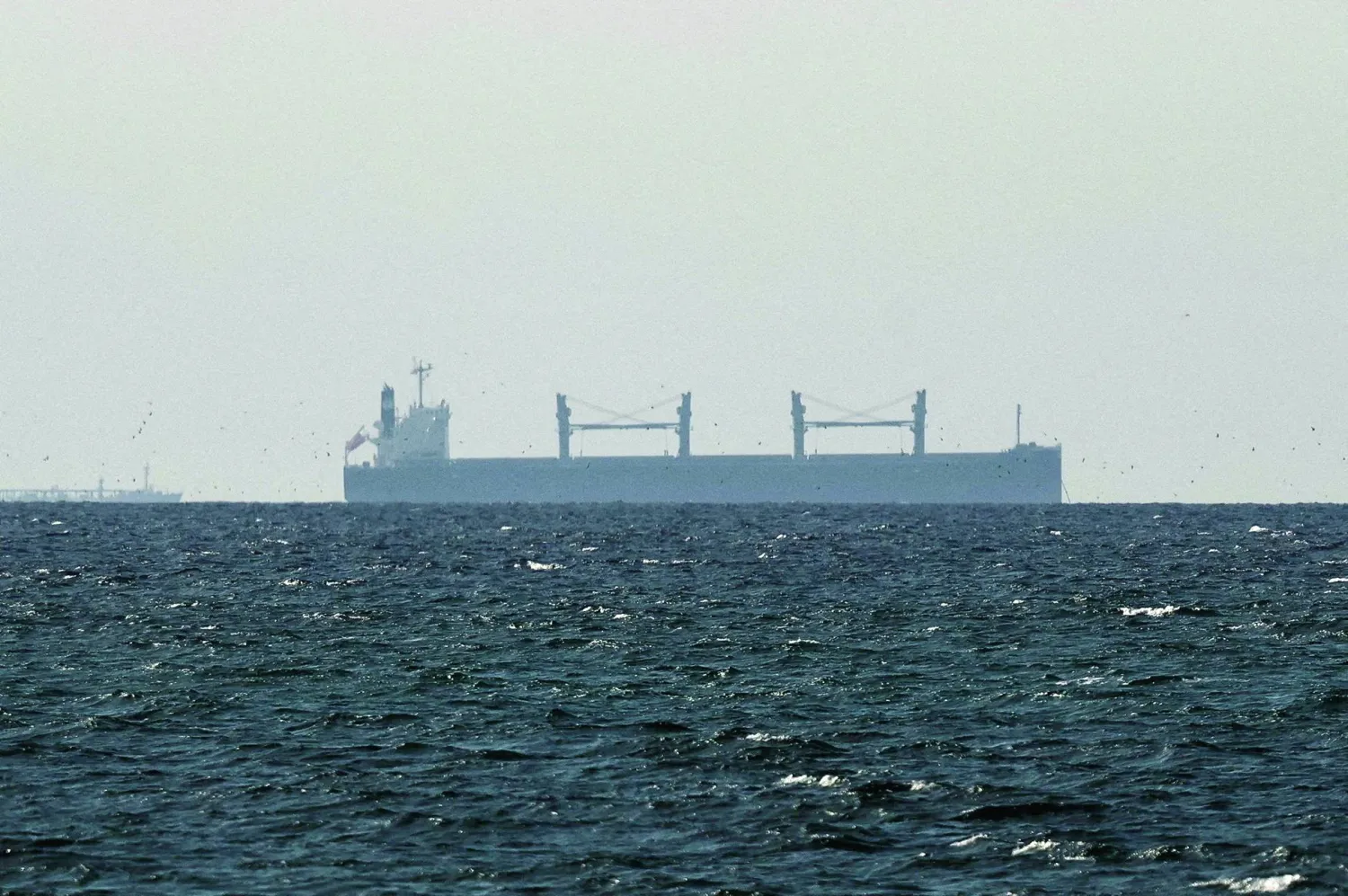 FILE PHOTO: A cargo ship in the Gulf, near the Strait of Hormuz, as seen from northern Ras al-Khaimah, near the border with Oman’s Musandam governance, amid the US-Israeli conflict with Iran, in United Arab Emirates, March 11, 2026. REUTERS