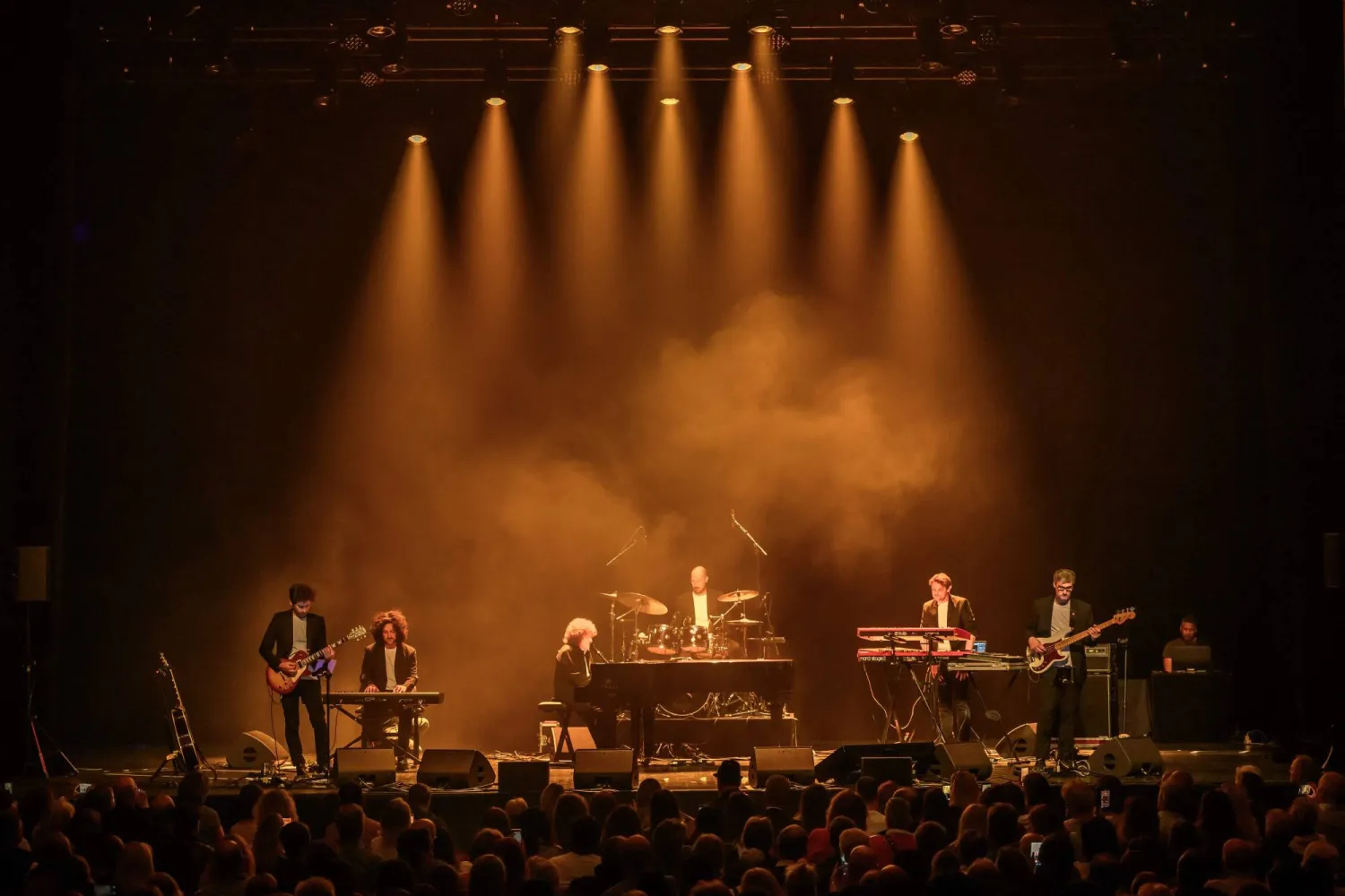 Italian and French singer and songwriter Riccardo Cocciante (C), also known as Richard Cocciante performs during a tribute concert entitled “Au cœur de Crans” for the victims of the New Year’s Eve bar fire in Crans-Montana, at the Salle Métropole in Lausanne on April 22, 2026.  (Photo by Fabrice COFFRINI / AFP)