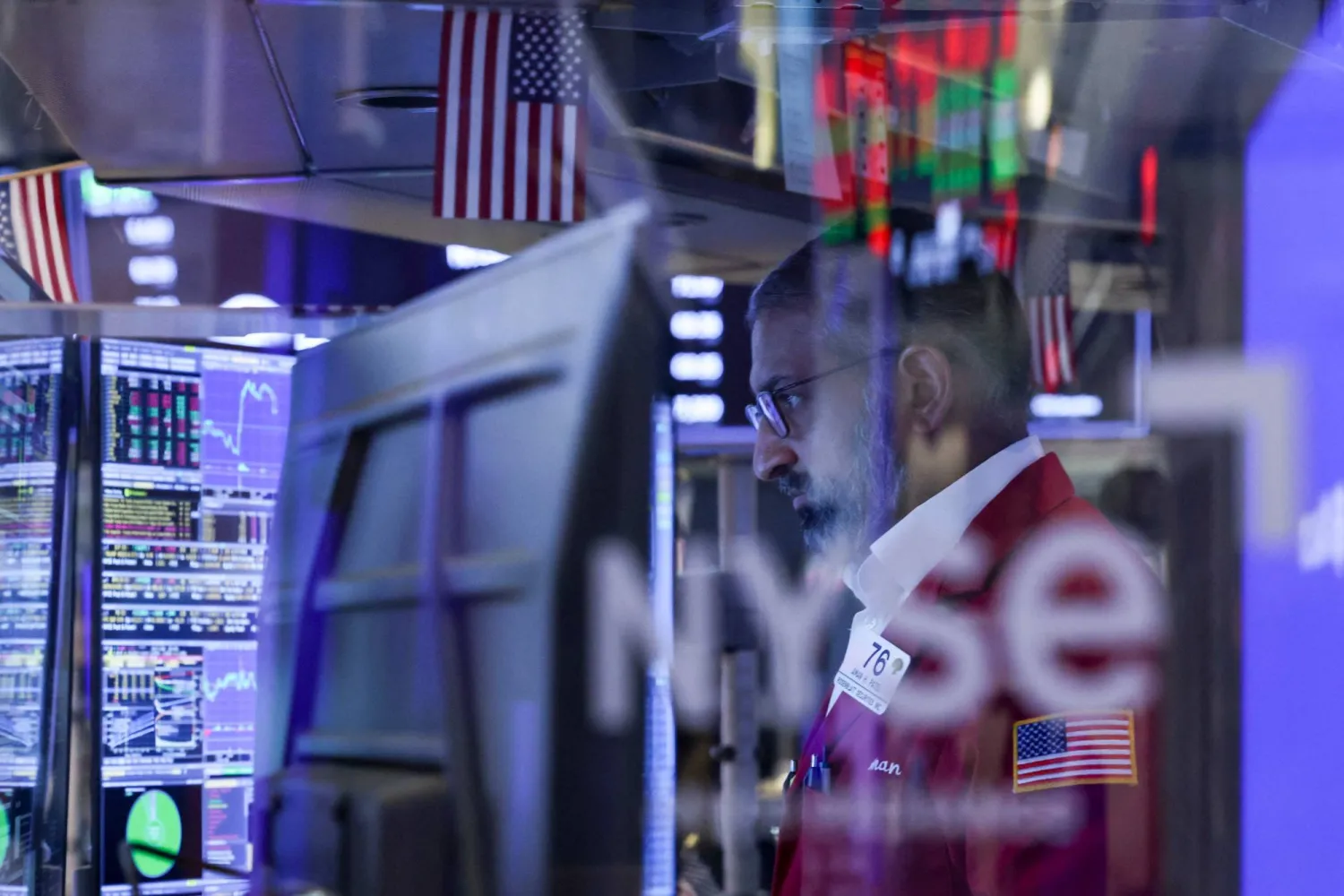 A trader works on the floor of the New York Stock Exchange (NYSE) at the opening bell in New York on March 24, 2026.  (Photo by ANGELA WEISS / AFP)