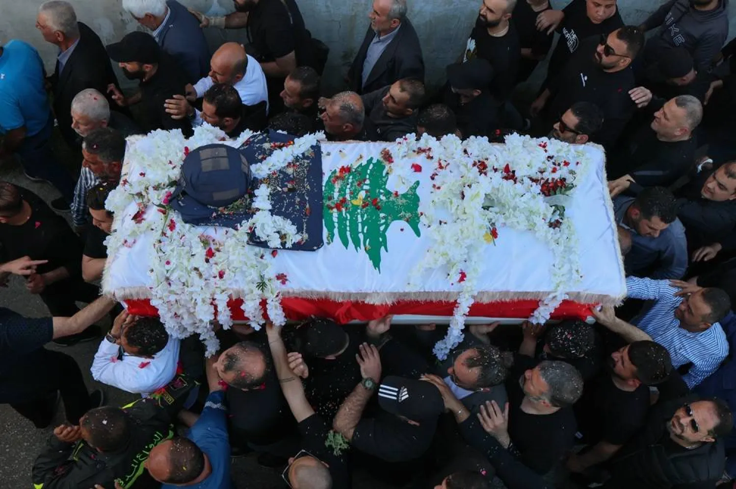 People carry the coffin of Lebanese journalist Amal Khalil during her funeral procession in the village of Baisariyah, southern Lebanon, 23 April 2026. (EPA)
